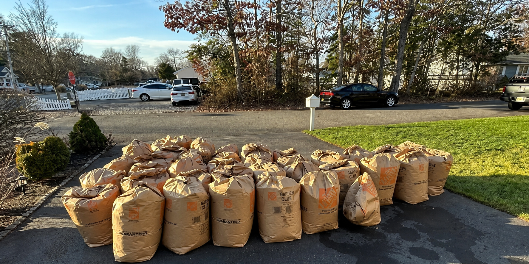 Large group of filled yard-waste bags after a Shore Property Care cleanup
